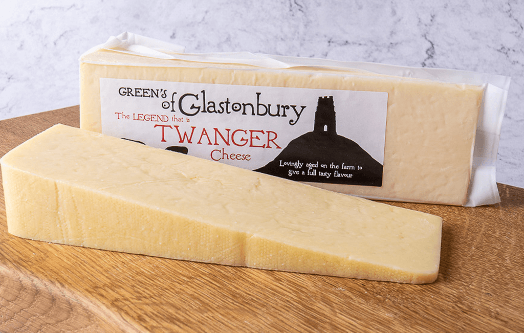 Two sets of twanger cheese from Green’s of Glastonbury on a wooden table.